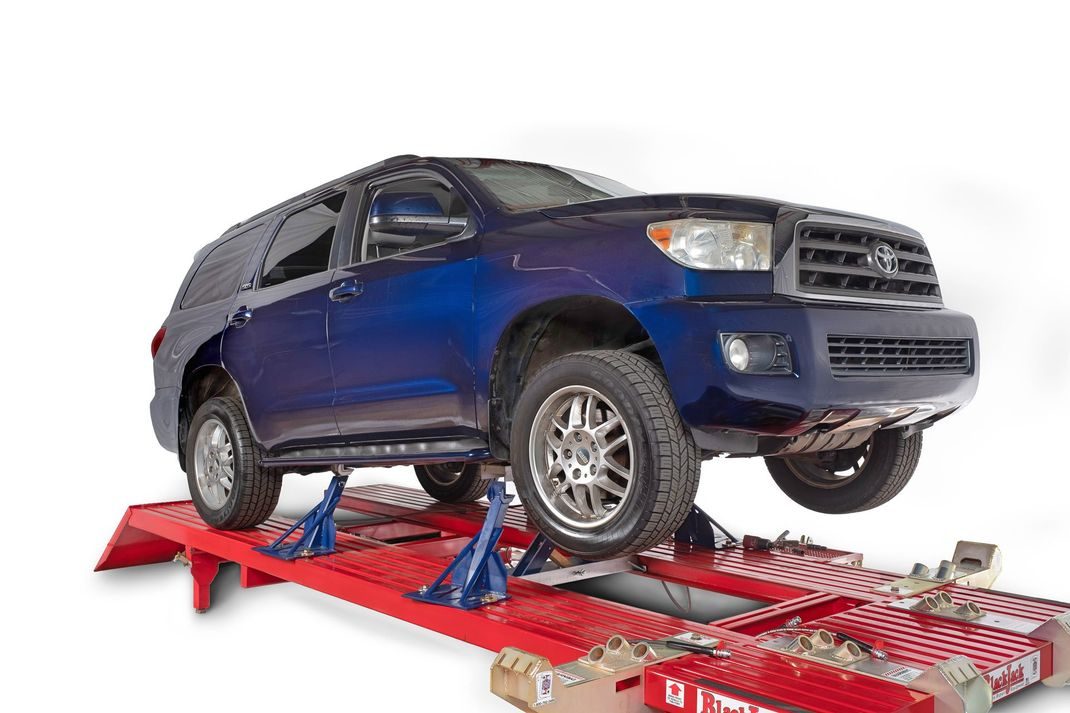 SUV lifted on a Black Jack frame machine